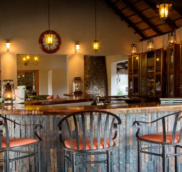 Elegant bar area at Arathusa Safari Lodge with stylish seating and warm lighting.