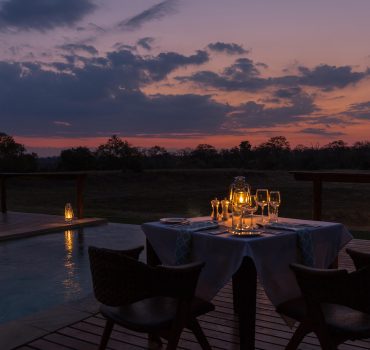 Elegant outdoor dining at Arathusa Safari Lodge during sunset