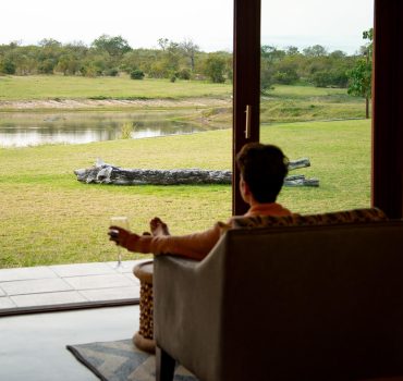 Water-facing suite at Arathusa Safari Lodge with a view of the lake and surrounding wildlife.